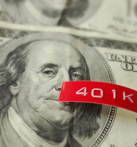 A red label printed 401K on top of a hundred dollar bill
