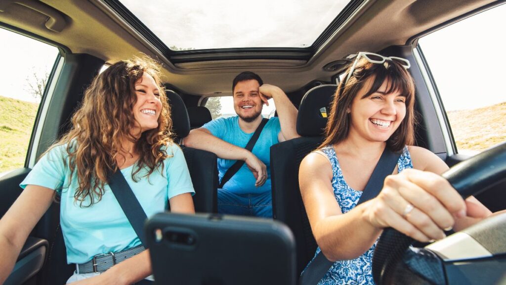 Friends driving in a car having fun on a roadtrip together
