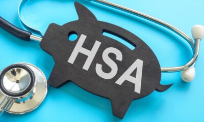A black wooden pig that says HSA on it next to a stethoscope